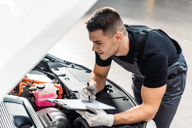 mechanic inspecting repossessed car
