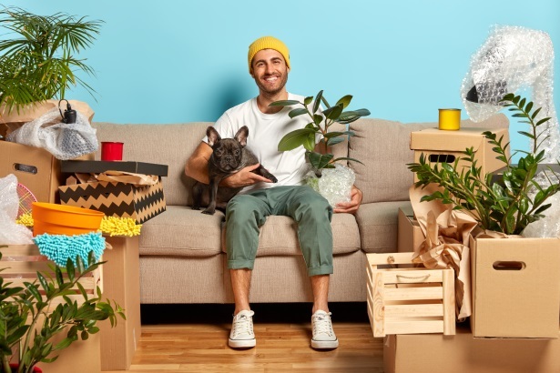 man with dog and moving boxes